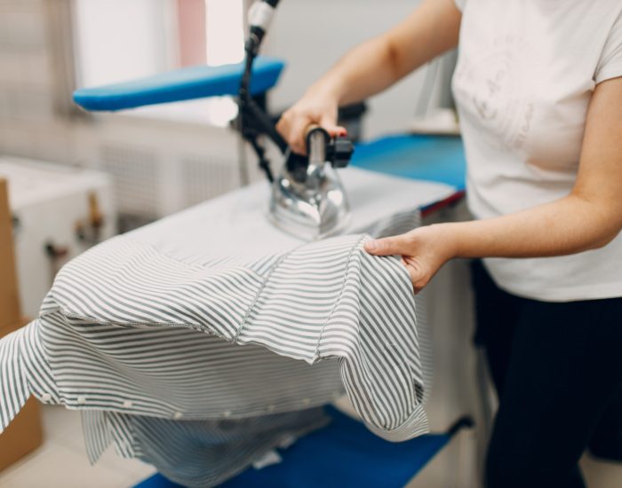 Dry cleaning clothes. Clean cloth chemical process. Laundry industrial dry-cleaning factory